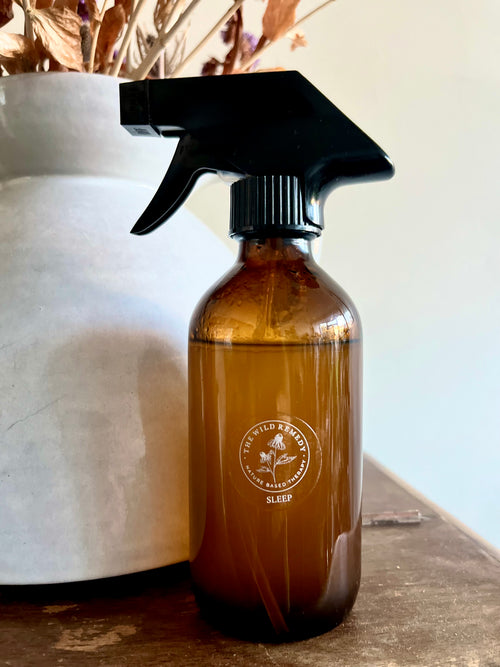 The Wild Remedy Botanical Pillow Spray bottle on bedside table
